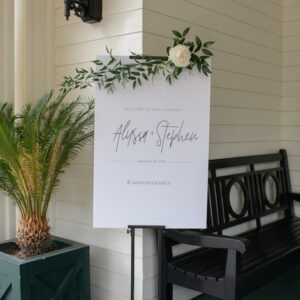 Black metal sign holder for weddings. Adjustable for any size available for rental through Lucky Day Events Co