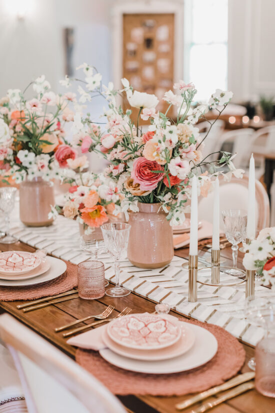 Elegant table setting with floral centerpieces.